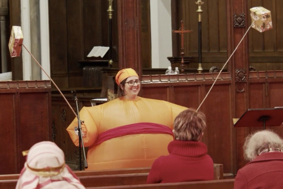 image of Emma Holton in church dressed as a Christingle